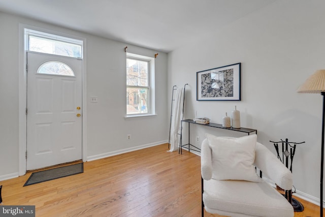 entryway featuring light wood-style flooring and baseboards