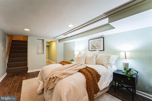 bedroom featuring a spacious closet, recessed lighting, baseboards, and wood tiled floor