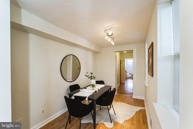 dining room with baseboards and light wood-style floors