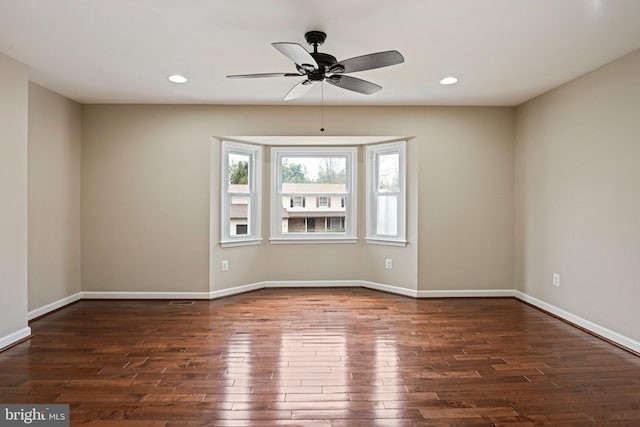 unfurnished room with hardwood / wood-style flooring, recessed lighting, and baseboards