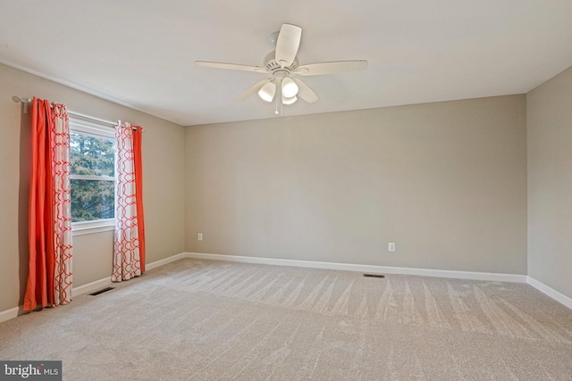 unfurnished room with visible vents, baseboards, ceiling fan, and carpet flooring