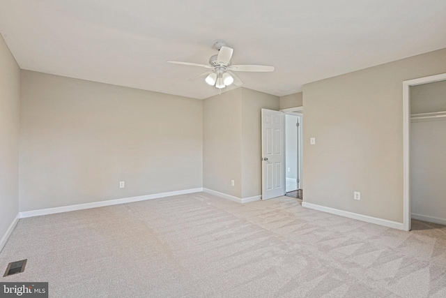 unfurnished bedroom with visible vents, baseboards, light colored carpet, a closet, and a ceiling fan