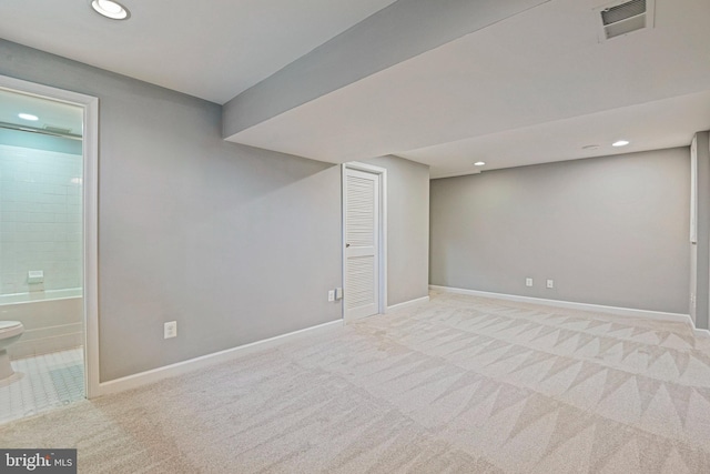 finished below grade area featuring recessed lighting, visible vents, baseboards, and carpet flooring