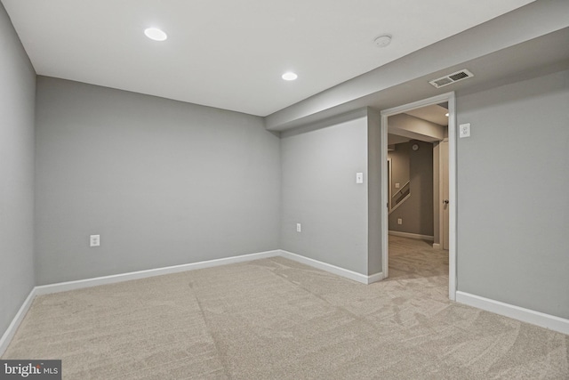 spare room with recessed lighting, visible vents, light carpet, and baseboards