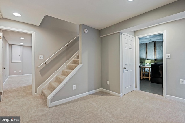 below grade area featuring carpet flooring, recessed lighting, stairs, and baseboards