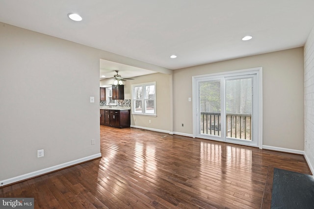 unfurnished living room with recessed lighting, baseboards, and hardwood / wood-style floors