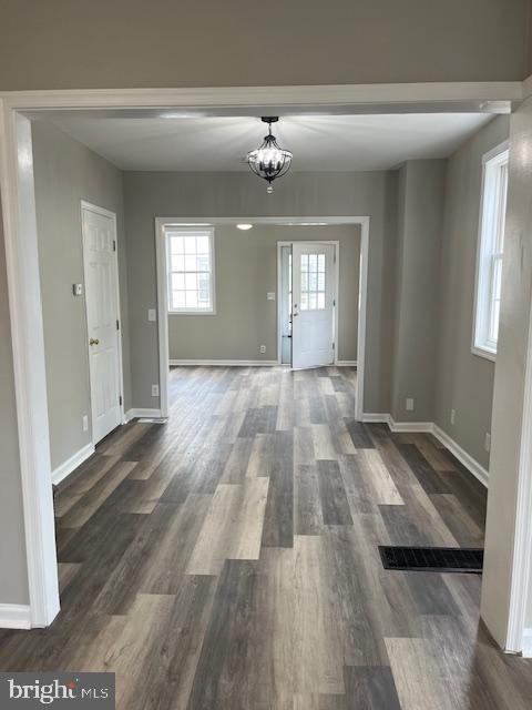 interior space with baseboards and dark wood finished floors