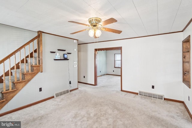 unfurnished living room with visible vents, ornamental molding, and ceiling fan