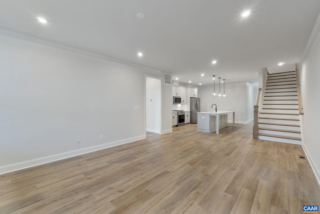 unfurnished living room with stairway, recessed lighting, light wood-type flooring, and ornamental molding