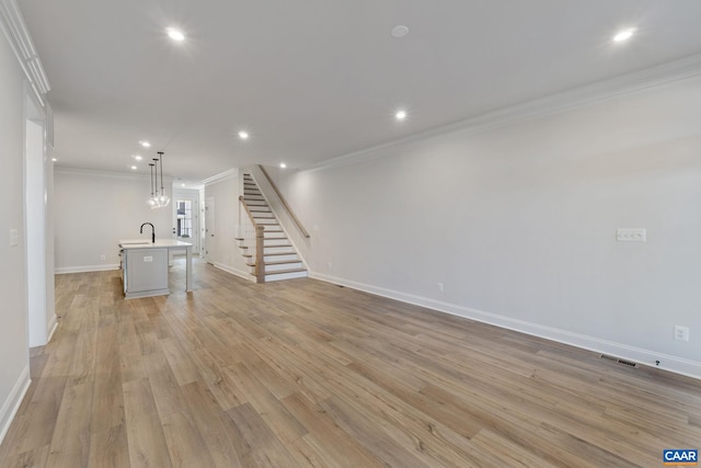 unfurnished living room featuring recessed lighting, visible vents, light wood-style floors, and crown molding