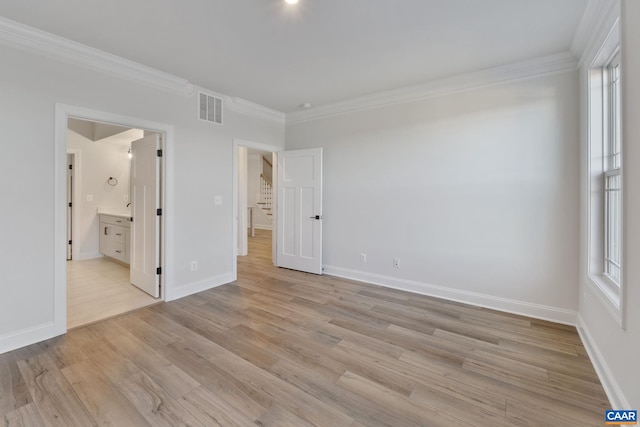 unfurnished bedroom with visible vents, baseboards, light wood-style floors, and ornamental molding