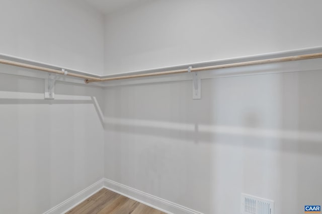 walk in closet featuring visible vents and wood finished floors