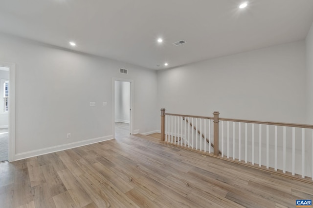 empty room featuring baseboards, recessed lighting, visible vents, and light wood-type flooring