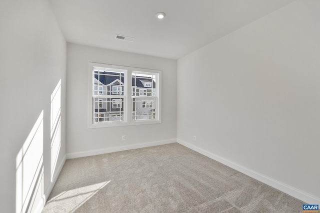 carpeted empty room with visible vents, recessed lighting, and baseboards