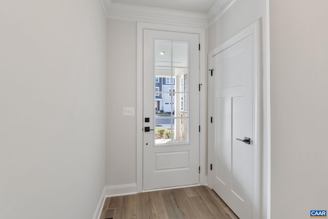 entryway featuring wood finished floors, visible vents, and baseboards