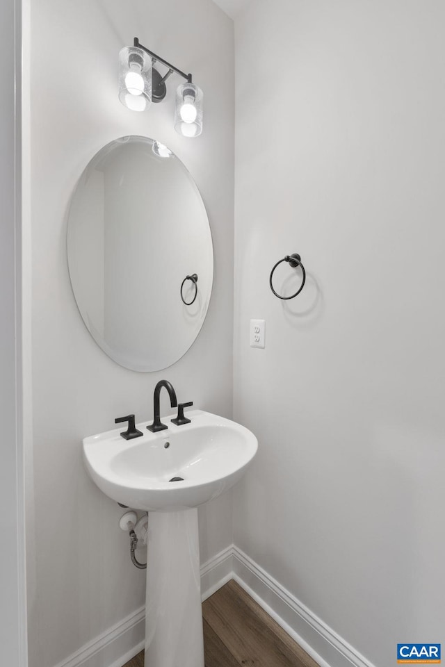 bathroom with wood finished floors and baseboards