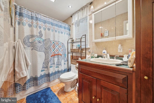 full bath with vanity, decorative backsplash, tile patterned floors, toilet, and tile walls