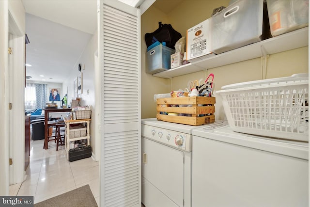 laundry area featuring light tile patterned flooring, laundry area, and washer and clothes dryer