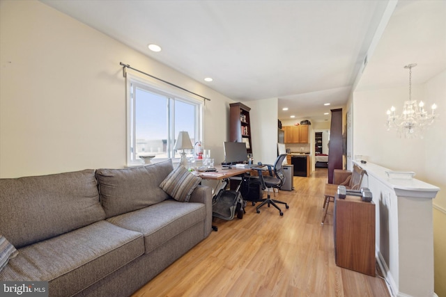 living area with light wood finished floors, a chandelier, and recessed lighting