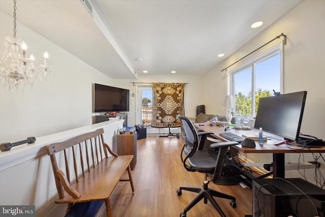 home office with a wealth of natural light, light wood-type flooring, a notable chandelier, and recessed lighting