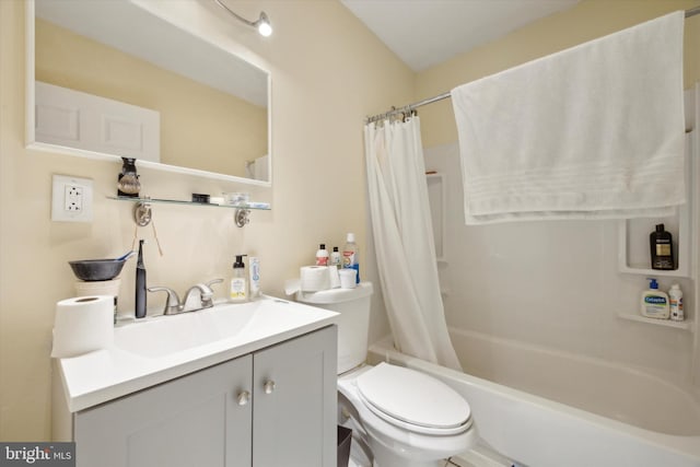 full bath featuring shower / bath combo with shower curtain, toilet, and vanity