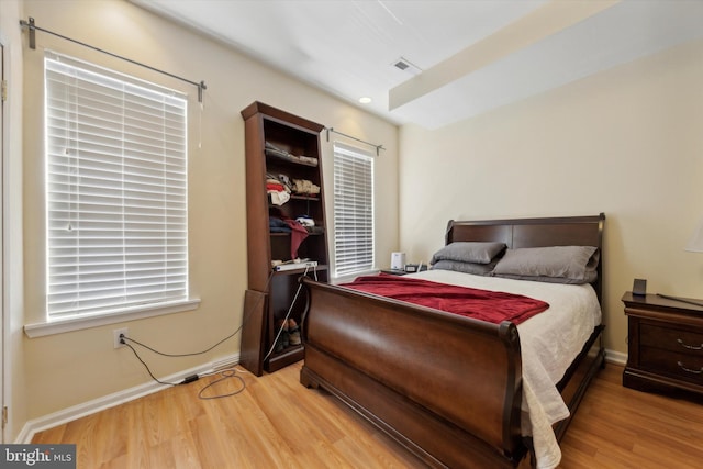 bedroom with visible vents, recessed lighting, baseboards, and light wood finished floors