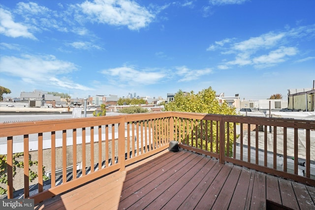 wooden terrace with a city view