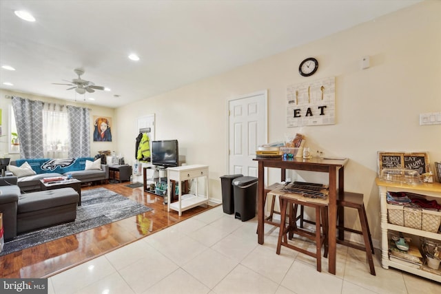 living area with light tile patterned floors, a ceiling fan, and recessed lighting