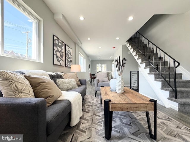 living area featuring recessed lighting, stairs, baseboards, and wood finished floors