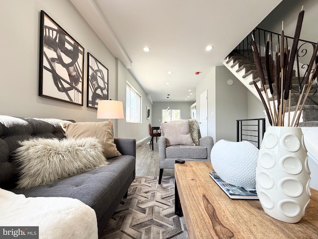 living room with recessed lighting, baseboards, wood finished floors, and stairs