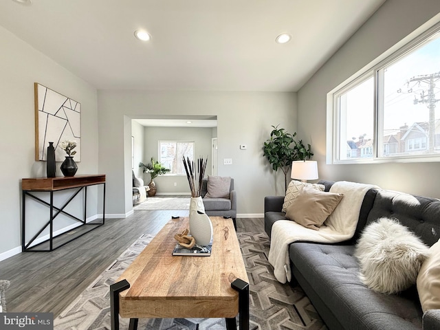 living room with recessed lighting, baseboards, and dark wood finished floors