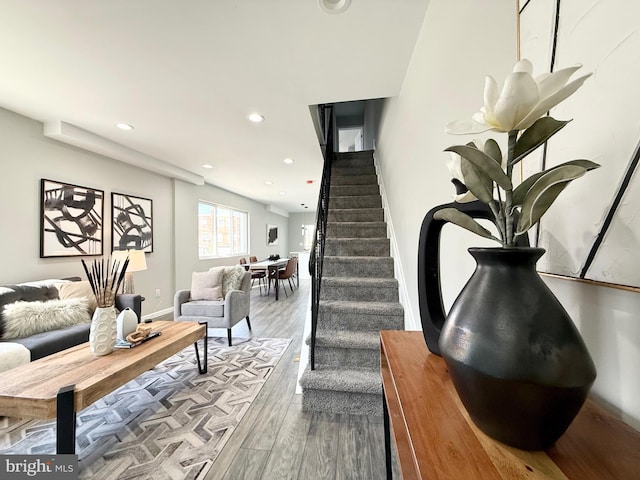 staircase featuring recessed lighting, baseboards, and wood finished floors