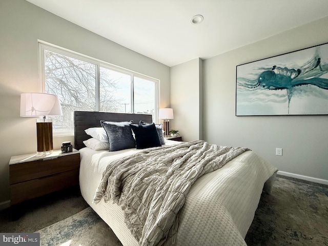 bedroom featuring baseboards and carpet