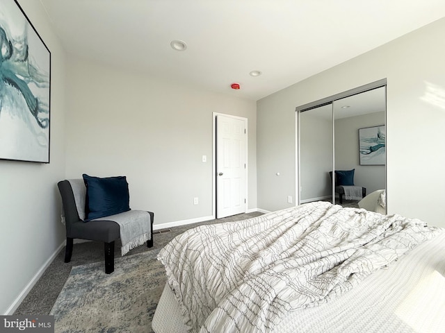 bedroom featuring carpet, baseboards, and a closet