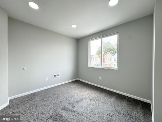 empty room featuring visible vents, recessed lighting, carpet, and baseboards