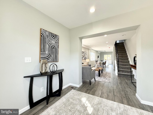 foyer featuring stairs, recessed lighting, wood finished floors, and baseboards