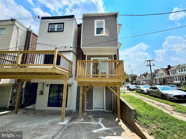 rear view of house featuring a wooden deck