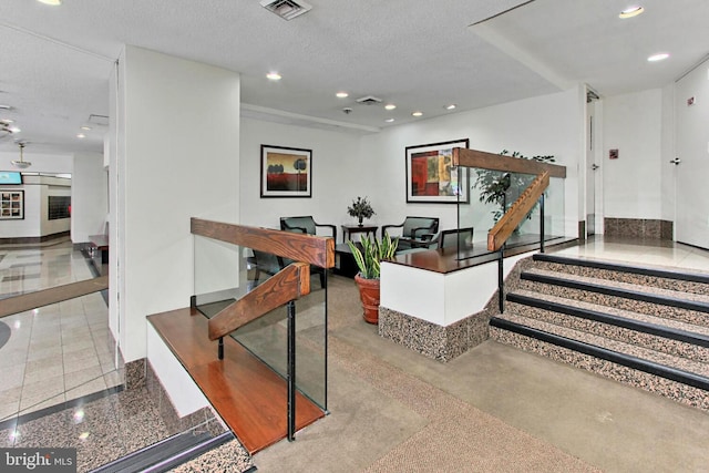 interior space featuring recessed lighting, visible vents, and a textured ceiling