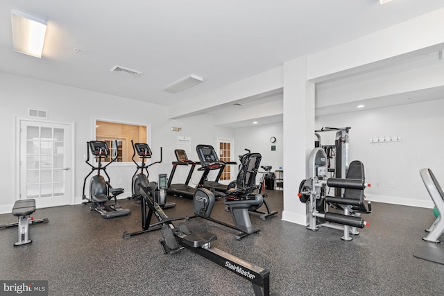 exercise room featuring visible vents and baseboards