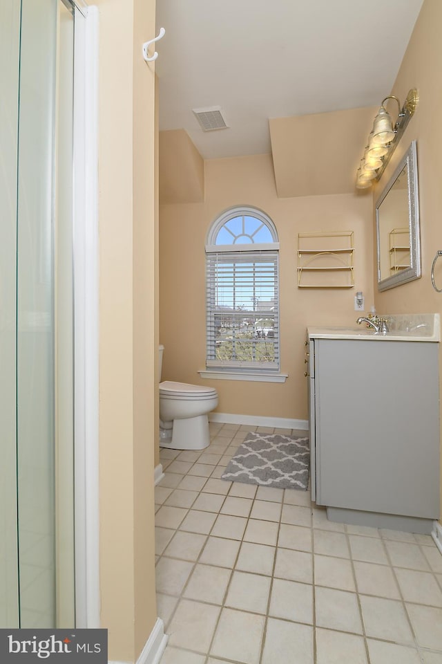 bathroom featuring tile patterned flooring, visible vents, baseboards, toilet, and vanity