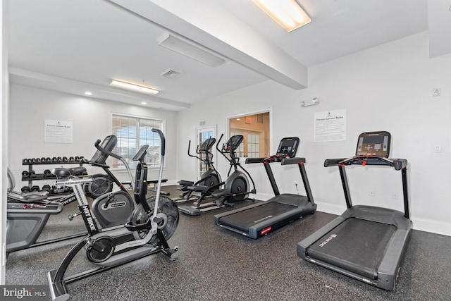 exercise room featuring visible vents and baseboards