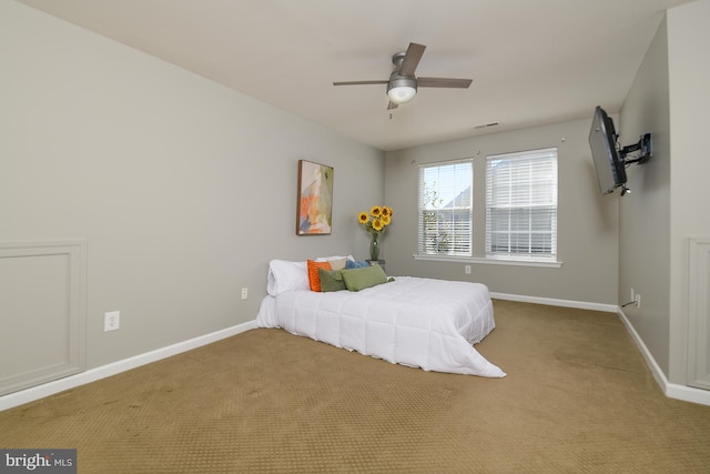 unfurnished bedroom with baseboards, carpet, and a ceiling fan