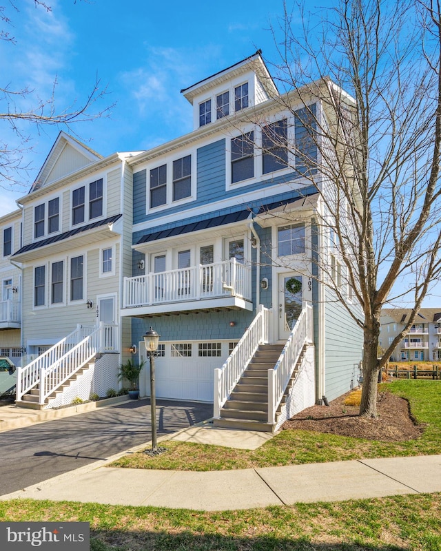 american foursquare style home featuring a garage and driveway