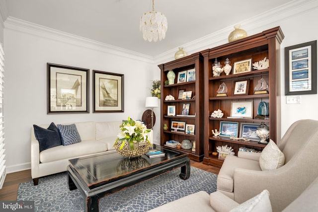 sitting room with an inviting chandelier, crown molding, dark wood-style flooring, and baseboards