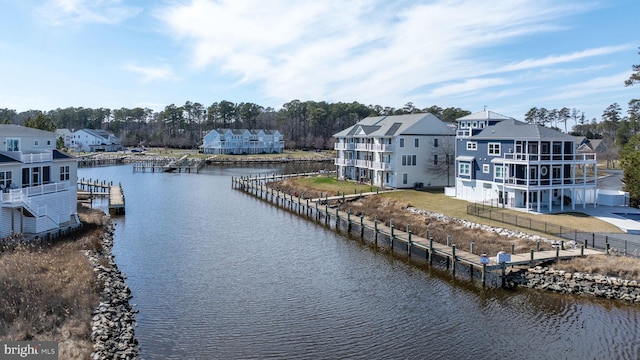 view of water feature featuring a dock and a residential view