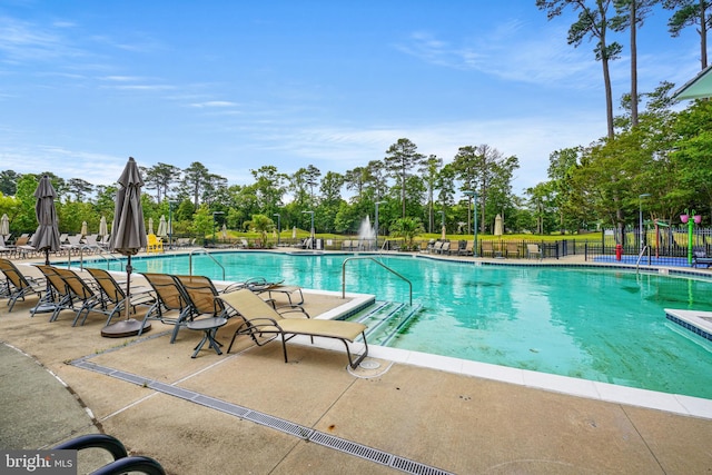 pool featuring a patio area and fence