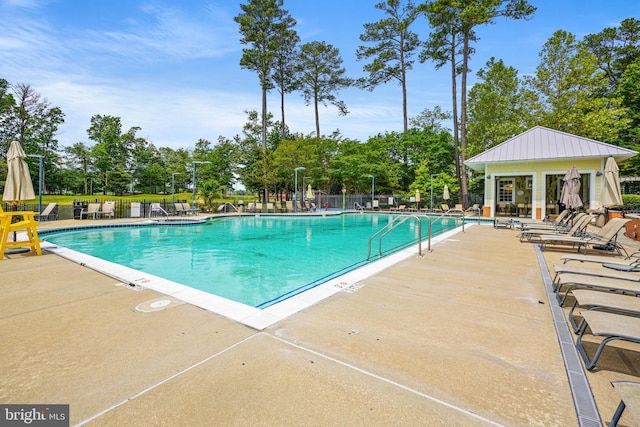 pool featuring a patio and fence