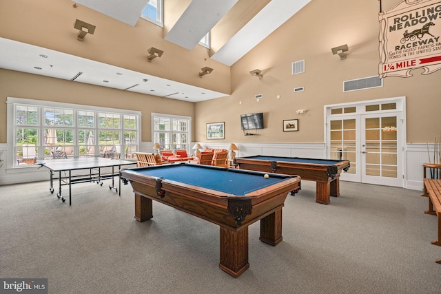 rec room with carpet flooring, wainscoting, and visible vents