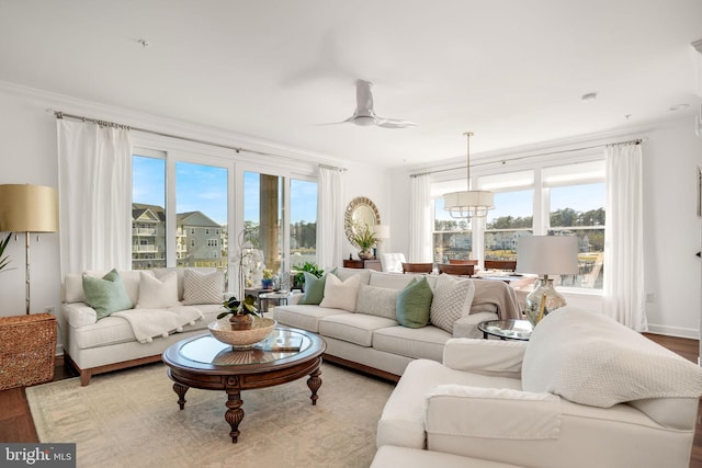 living room featuring plenty of natural light, wood finished floors, and ornamental molding