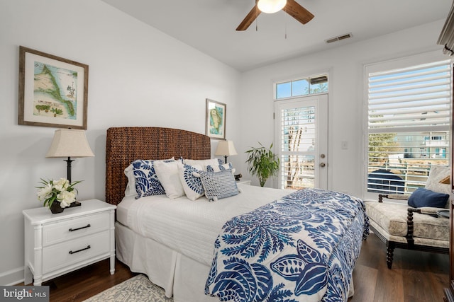 bedroom with dark wood-style floors, visible vents, ceiling fan, and access to outside